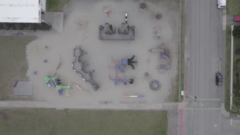 top down view of empty childrens jungle gym as seagull flies around