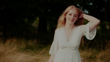 Attractive-Boho-Woman-Walking-On-A-Meadow-In-Summer-Holding-Flowers-In-Hand-2