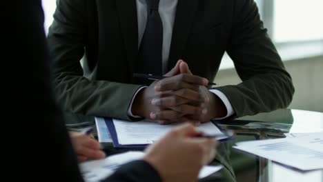 cheerful businessman discussing finances with businesswoman