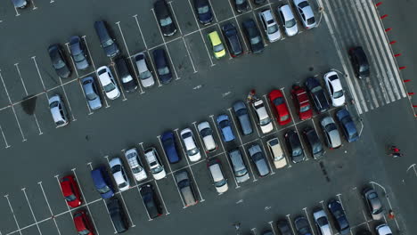 copter filming people walking at parking. drone footage car riding at parking