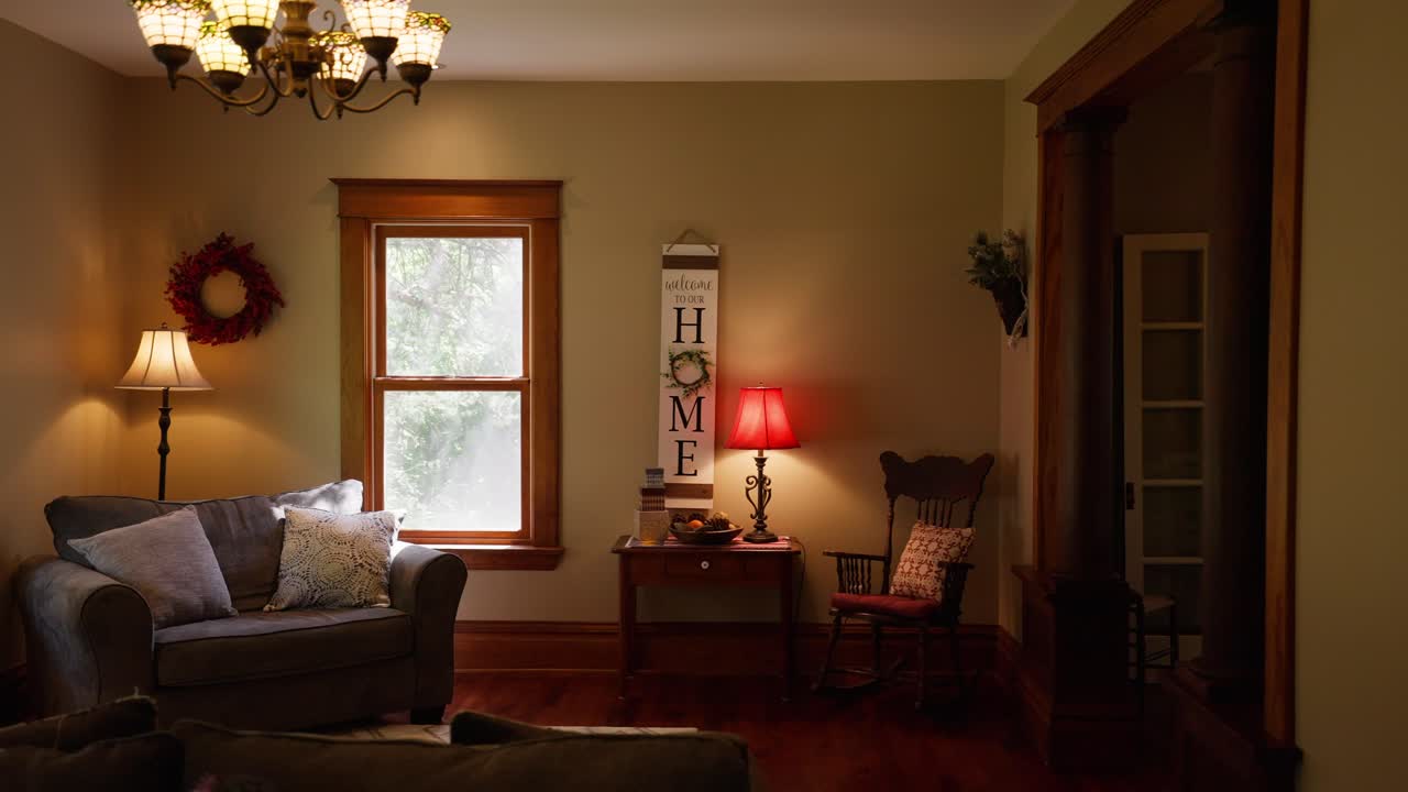 panning shot of a cozy living room in a home with a sign that reads &amp;quot;home&amp;quot; on the wall