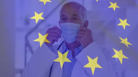 Animación-De-La-Bandera-De-La-Unión-Europea-Y-Estadísticas-Con-Un-Médico-Varón-Poniéndose-Una-Mascarilla