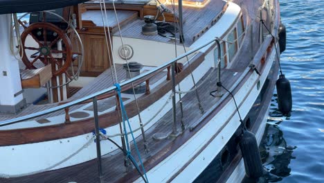wooden sailboat moored to the port in the sea water