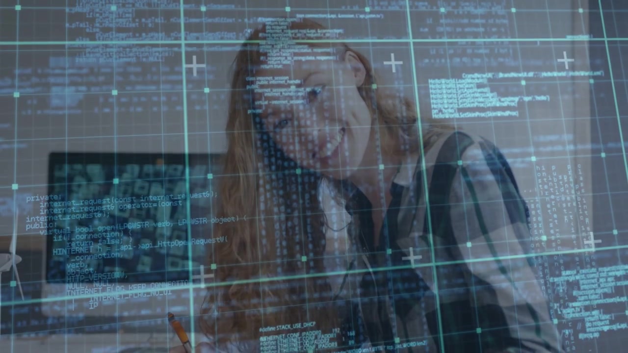 Woman leaning over desk reading faint HUD overlay appearing, analyzing tech code and grid on screen