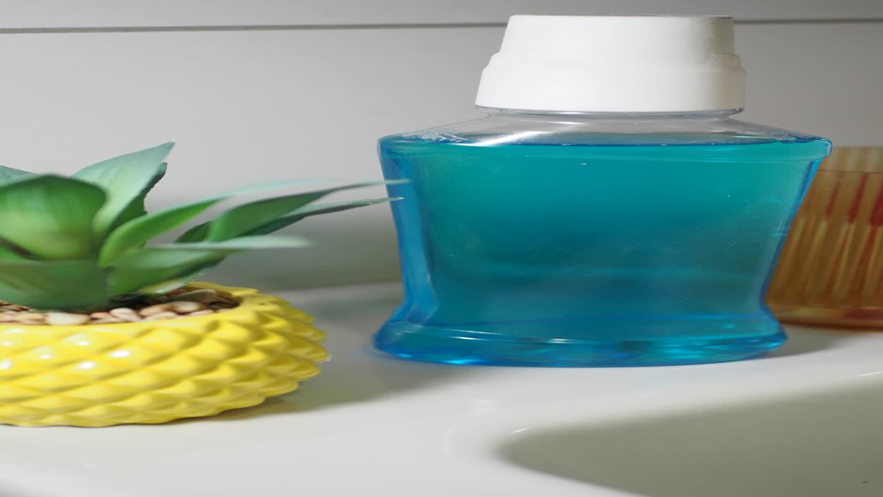 Mouthwash and Toothbrush on Bathroom Sink