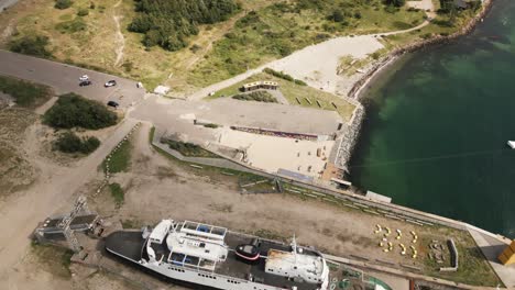 Altes-Boot-Im-Hafen-In-Der-Nähe-Einer-Großen-Brücke-über-Das-Meer