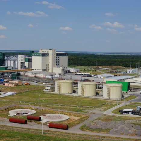 modern granary elevator. silver silos on agro-processing and manufacturing plant. agricultural products, flour, cereals and grain. aerial view video panorama.