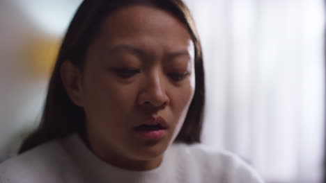 Close-Up-Of-Stressed-Or-Anxious-Woman-Suffering-With-Depression-Anxiety-Or-Loneliness-Sitting-In-Room-At-Home-4