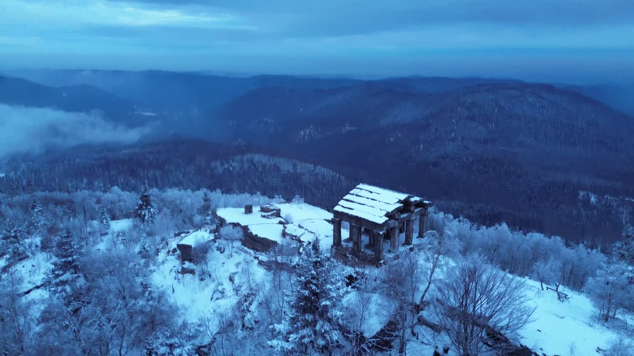 Temple du Donon covered in fresh winter snow, aerial drone view in the Vosges Mountains.