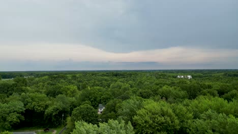 A-tranquil-view-of-dense-green-forest-canopy-against-a-cloudy-sky,-ideal-for-environmental-and-nature-themed-projects