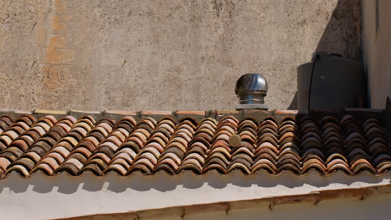 Traditional tiled roof under sunny sky in Scopello, Sicily, Italy