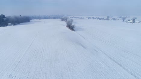 aerial view of early morning sunrise after a snow fall in amish countryside as senn by s drone