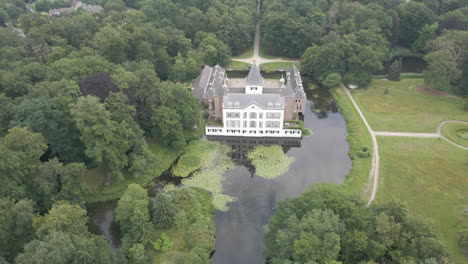 Jib-down-of-beautiful-mansion-surrounded-by-water-and-trees