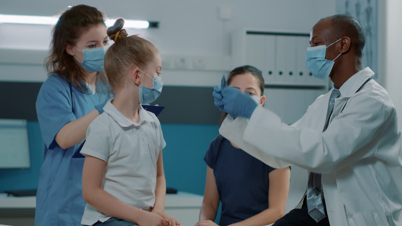 Medical examination with doctor, nurse, child and mother
