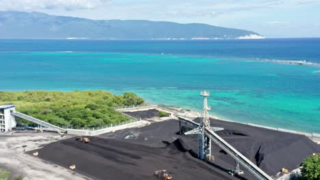 Massive-stockpile-of-coal-in-open-air-facility,-wheel-dozers-at-work