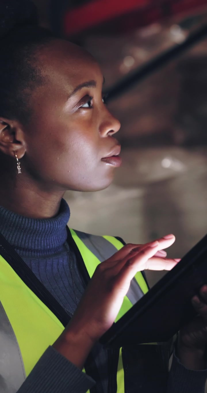 Warehouse Worker Using Digital Tablet for Inventory Management