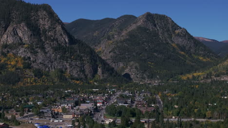 Downtown-Frisco-Colorado-aerial-cinematic-drone-early-yellow-fall-colors-Aspen-trees-morning-Lake-Dillon-Keystone-Breckenridge-Silverthorne-Ten-Mile-Range-peaks-blue-sky-circle-left-movement