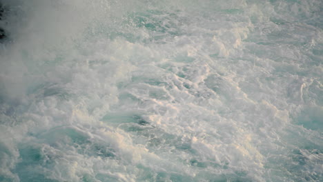 sea splashes breaking by hill outside closeup. scenic stormy water landscape