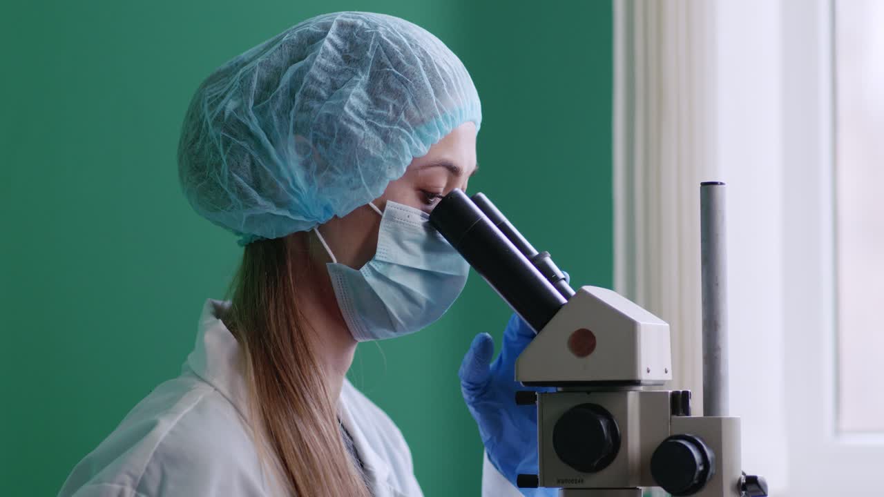 Female Scientist Using Microscope