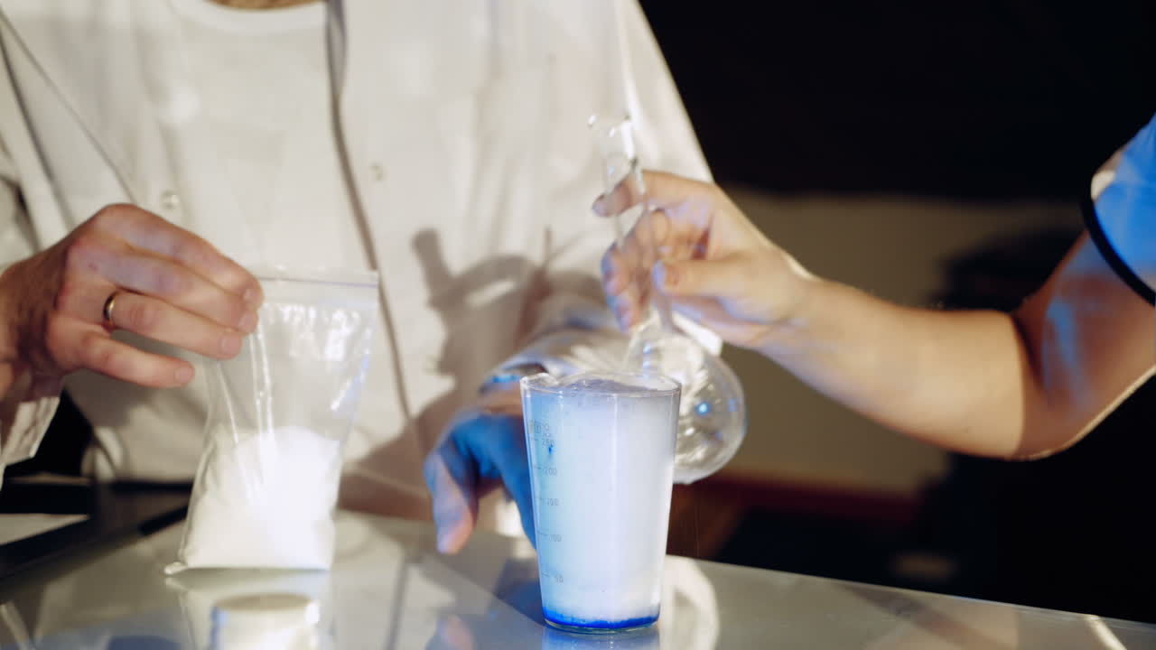 Lab worker mixes chemicals. Experiments in the laboratory. Close-up