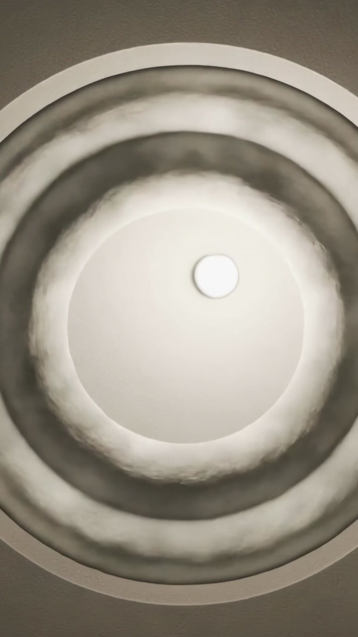 Vertical video: Tilting camera revealing ceiling light, bright spot shifting, crescent shadow