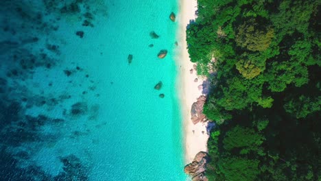 tropical perhentian islands in malaysia, beautiful aerial drone cinemagraph / seamless video loop in 4k uhd. clear blue water moving gently in waves, white sandy beaches and palm trees. perfect place for island adventures and honeymoon.