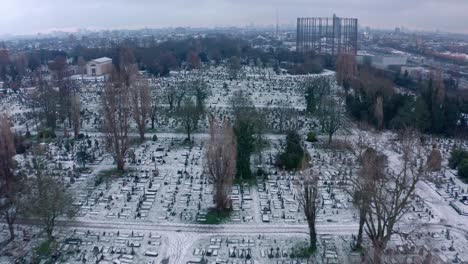 dolly forward aerial drone shot over kensal green cemetary london in winter snow