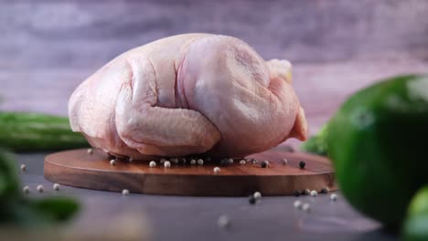 raw chicken on wooden board with vegetables