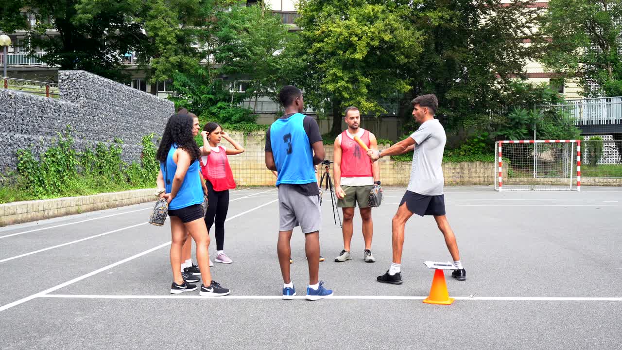 Group of people playing baseball outdoors