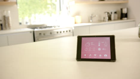 A-smart-home-interface-sits-on-a-kitchen-counter,-copy-space