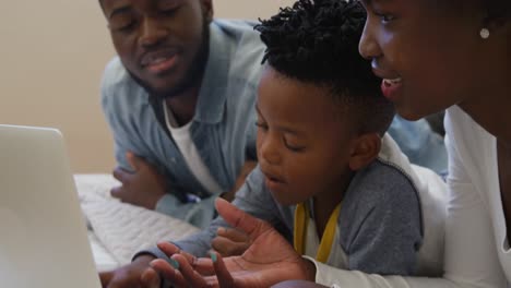 family using laptop together at home