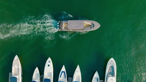 top down drone shot of a boat exit the parking, marina, colombia, cartagena