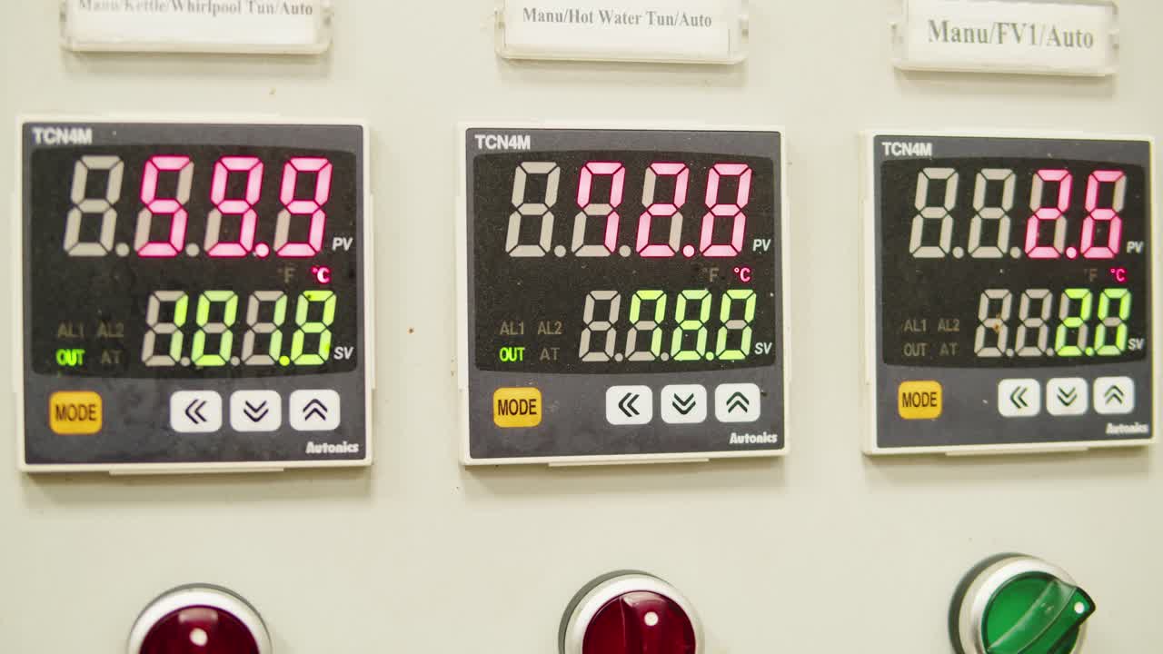 Craft beer production factory, brewery manufacture. Putting barley malt grains in conveyor close-up. Brewing, cooking alcohol in metal vats bottles