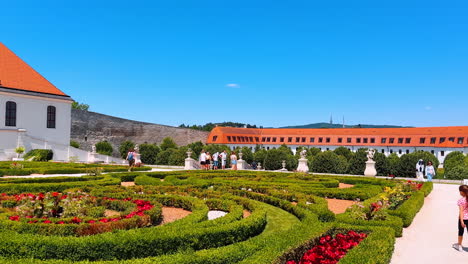 bratislava, slovakia, 2 june 2025: beautiful garden surrounded by old buildings and sculptures. lovely flower-beds near the bratislava castle in slovakia