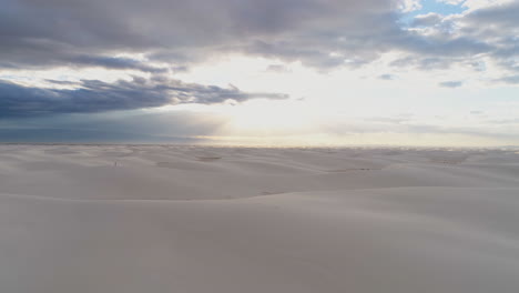 4k aerial of beautiful endless white sand dune field with people for scale