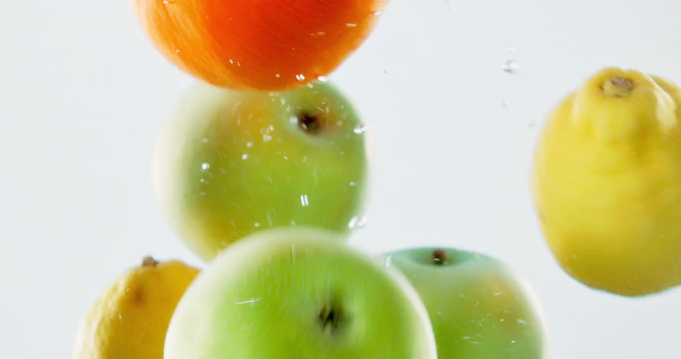 Fresh Green Apples Floating in Water