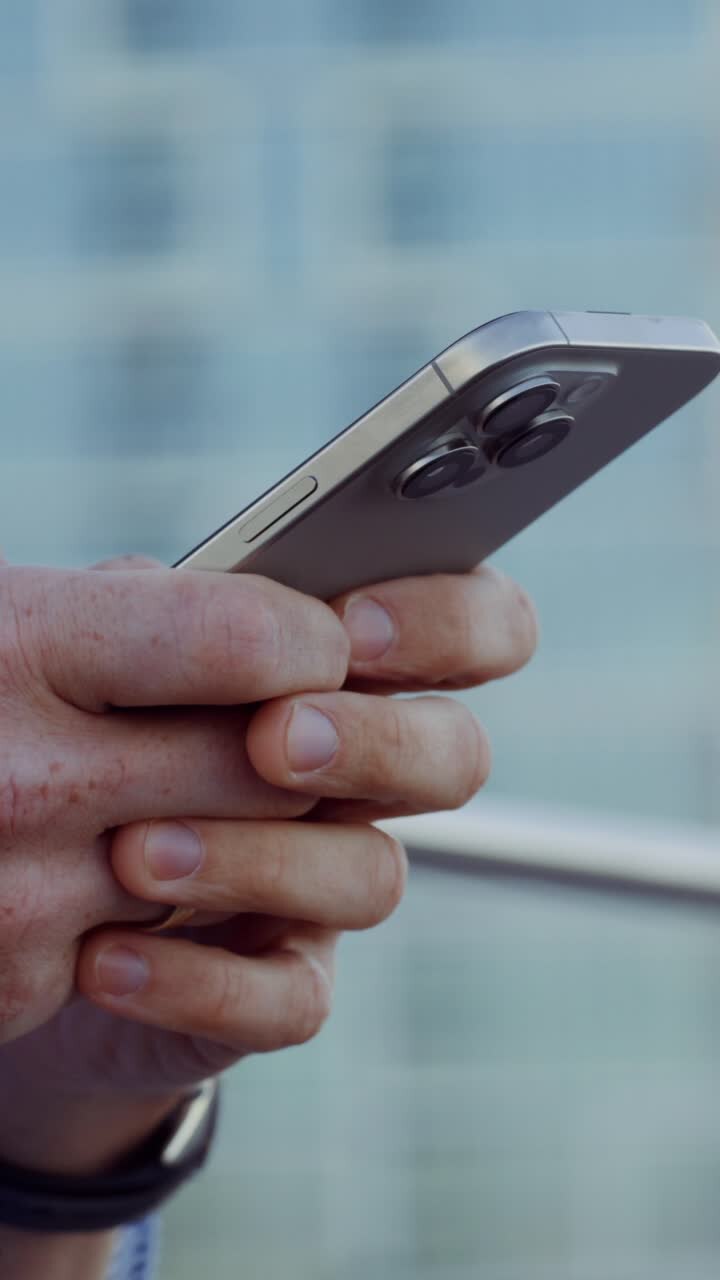 Person holding a silver iPhone