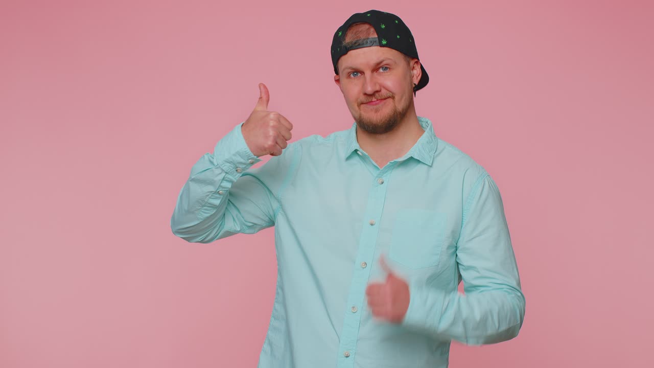 Man pointing down saying to subscribe gesturing ok and like showing place for commercial info