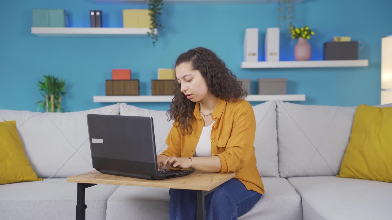 la mujer joven mirando la computadora portátil es reflexiva.