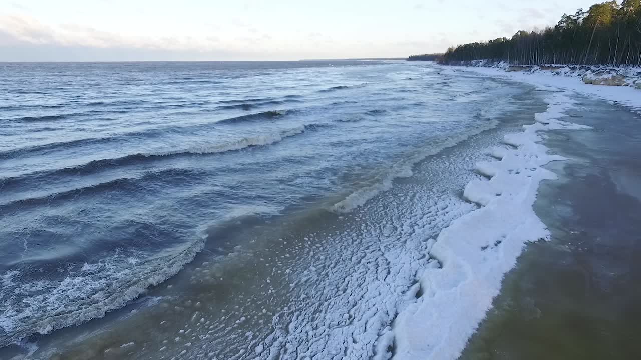 Seaside icy waves in winter morning light