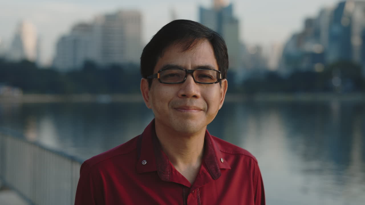 Portrait of a man by a lake in the city