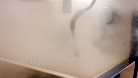 hot steam coming out of a cappuccino coffee machine