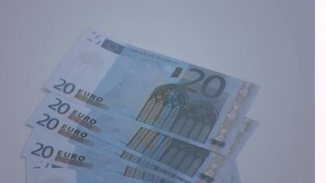 animation of close up of euro bills flying against grey background