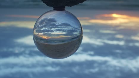 magic sunset view on the beach in a crystal ball.