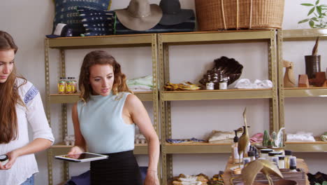 shop assistant talks to a customer and shows her products, shot on r3d