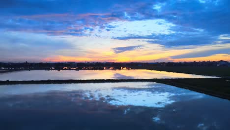 Tranquil-drone-footage-of-a-colorful-twilight-sky-being-reflected-off-the-surface-of-lakes-in-Thailand