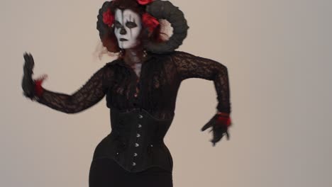 catrina cosplay girl tilt up while sensually moving with a light background , medium shot 2
