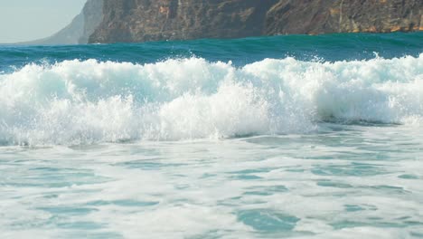 Tracking-follow-shot-of-strong-powerful-shorebreak-waves-crashing-and-rolling-to-beach