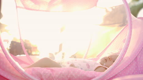 baby girl in the light of bright summer sunshine