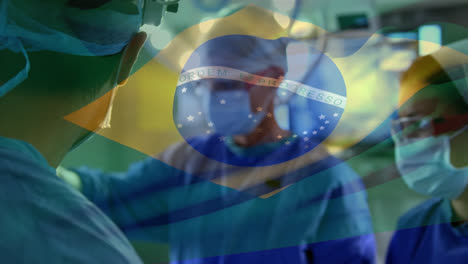 animation of waving brazil flag against team of diverse surgeons performing operation at hospital